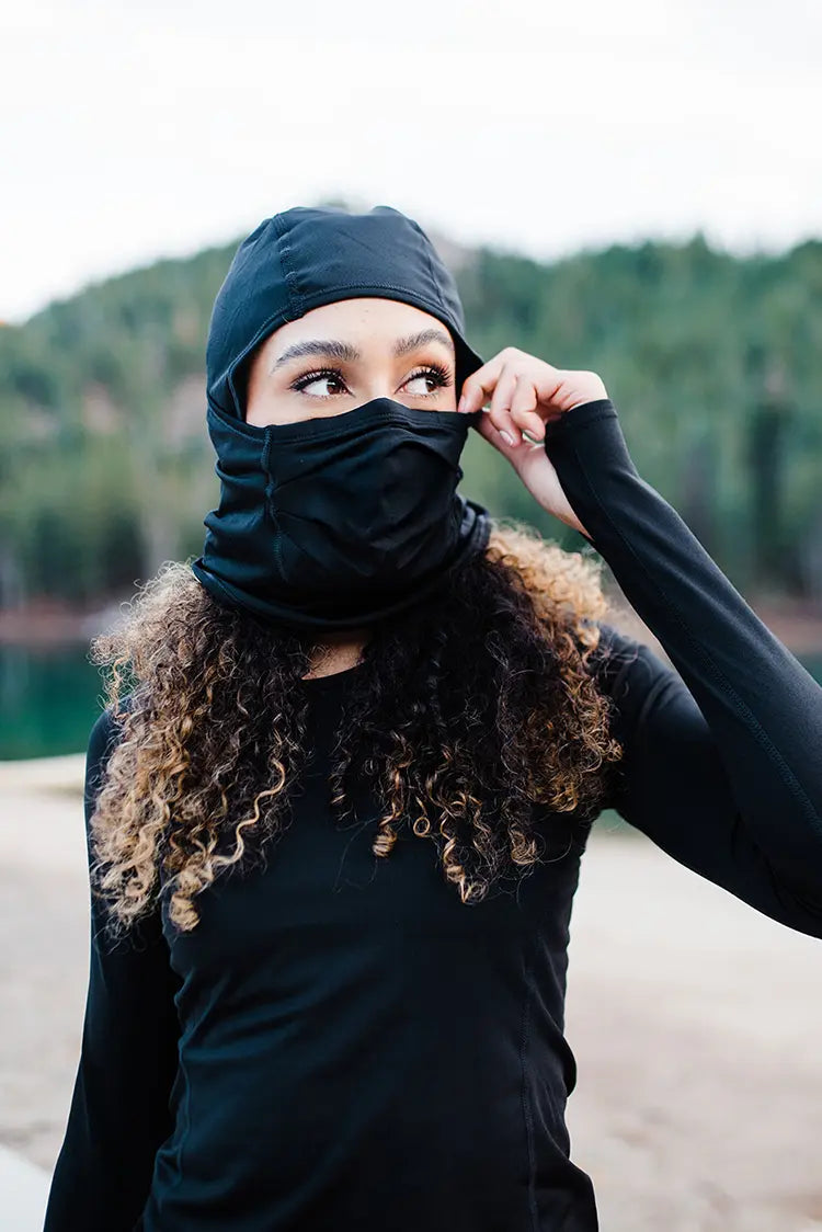 Woman wearing Hot Chillys winter sport mask while enjoying mountain outdoors