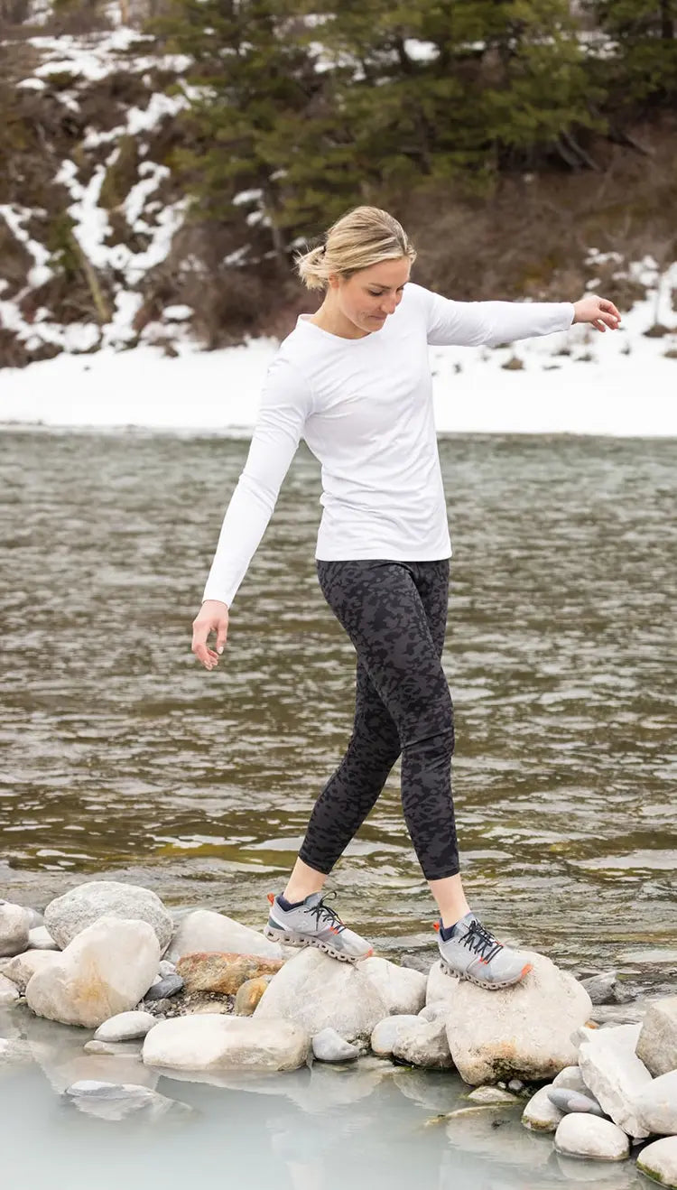 Woman wearing Hot Chillys thermal base layers for outdoor adventure